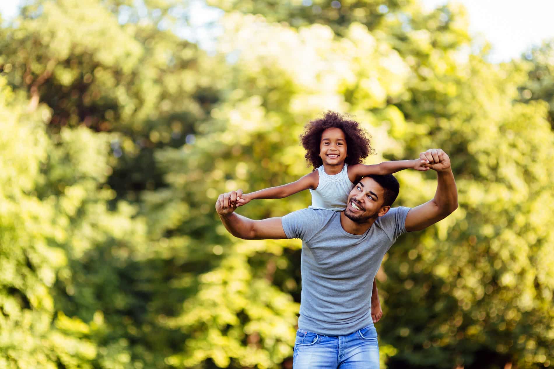 Father and daughter play together after family dental care at bear canyon Dental