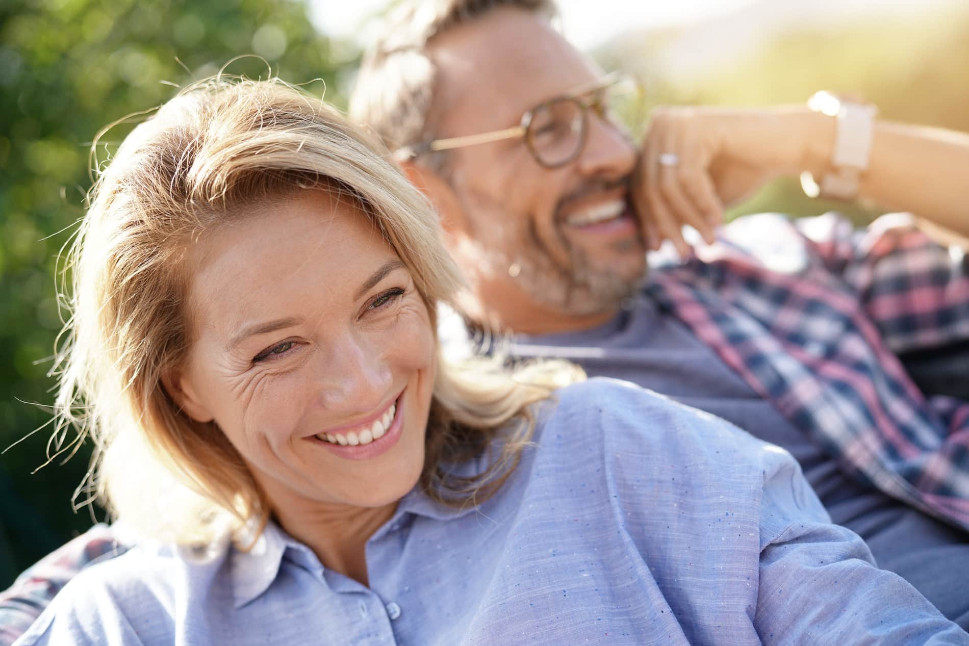 Couple showing off their restored smiles with Bear Canyon Dental